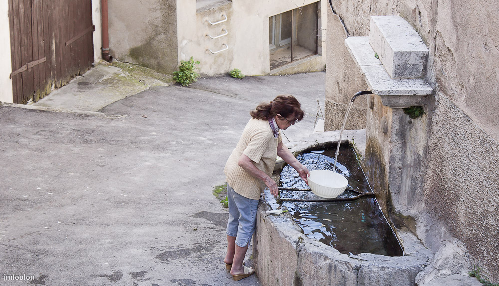 moustier-019.jpg - Moustiers au quotidien: Femme lavant ses légumes à la fontaine dans le centre du village